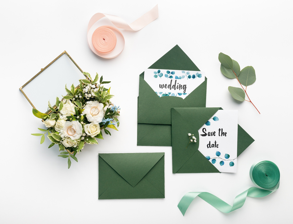 Creative green envelopes with white wedding invitations